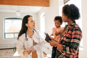 Family doctor attending toddler