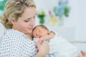 Holding Her Newborn's Hand